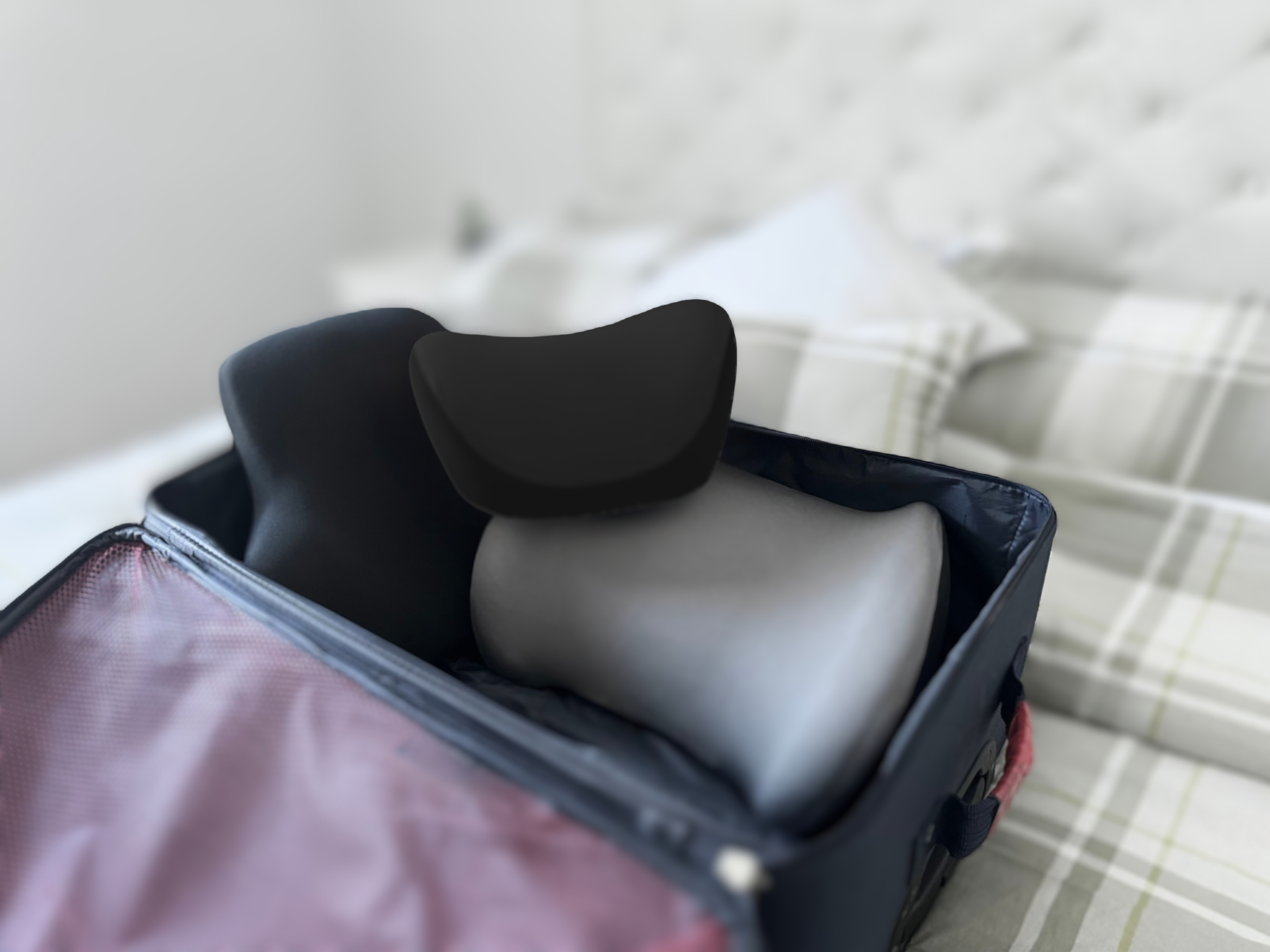 Ergonomic comfort products including lumbar support pillow, neck support cushion, and other travel essentials packed in a suitcase for on-the-go comfort