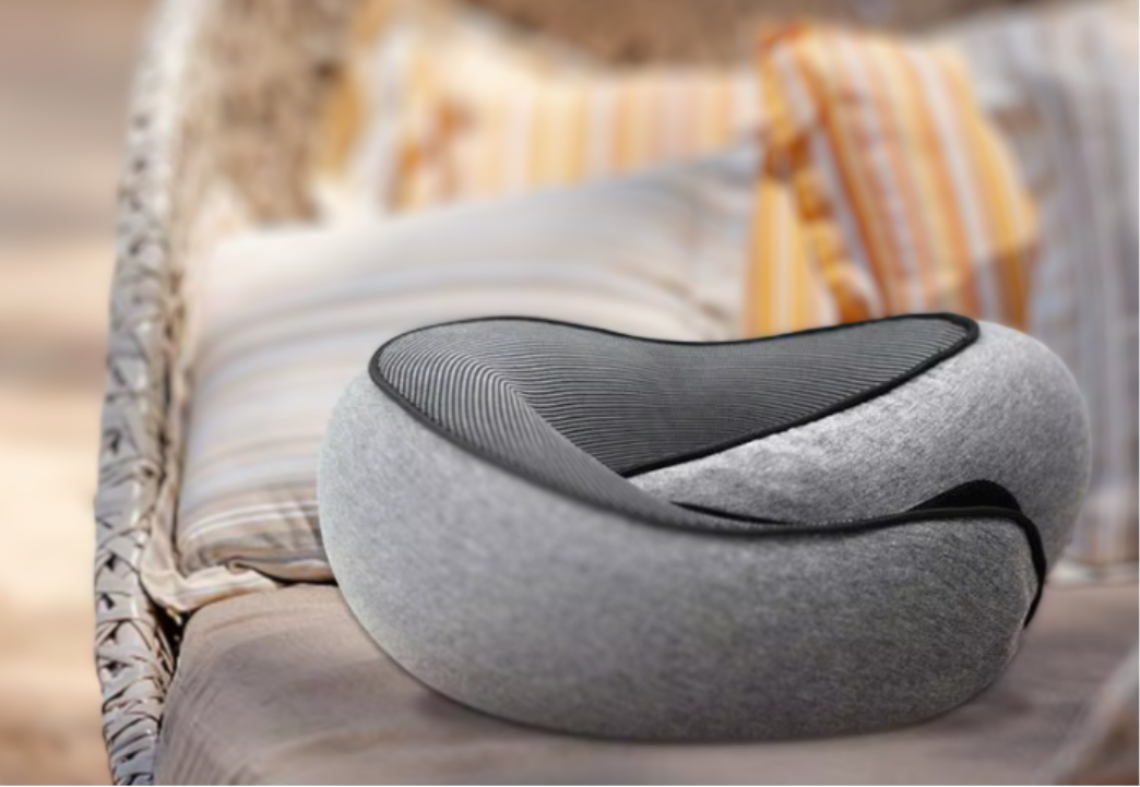 Relaxing on the beach with the neck travel pillow, providing ultimate comfort and support for neck and head during travel or relaxation